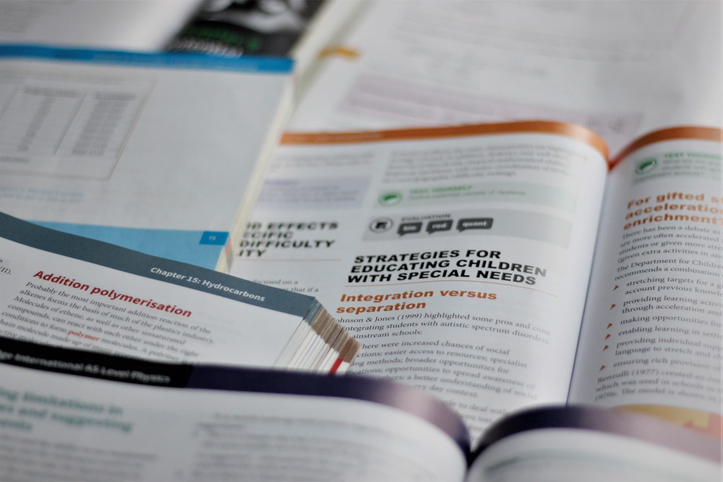 Open textbooks displaying educational subjects and scientific diagrams.